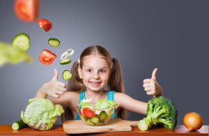Beautiful girl with fresh vegetables